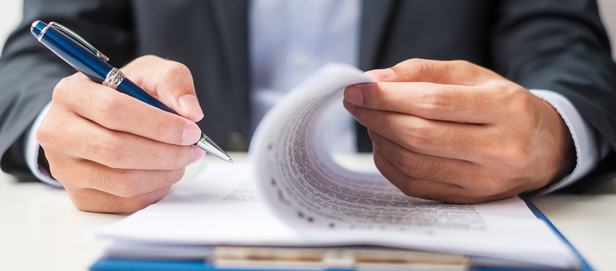 Businessman signing on contract documents after reading, man holding pen and approve